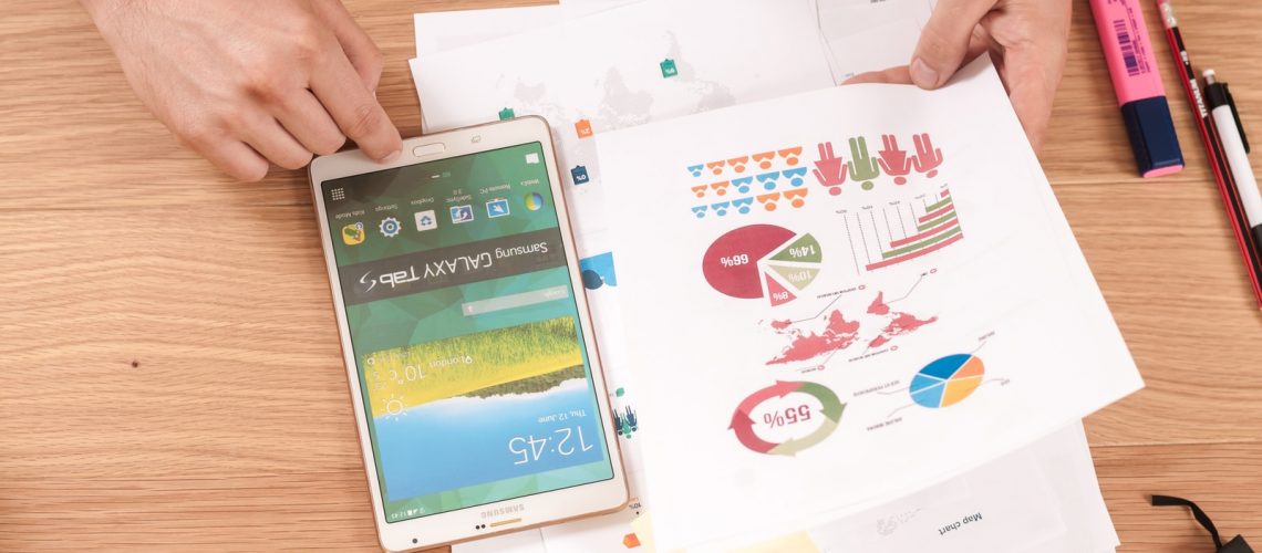 person holding white Samsung Galaxy Tab